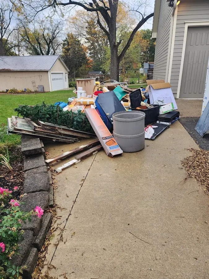Dumpster being loaded with debris for 3 Yard Dumpster Rental in Hastings
